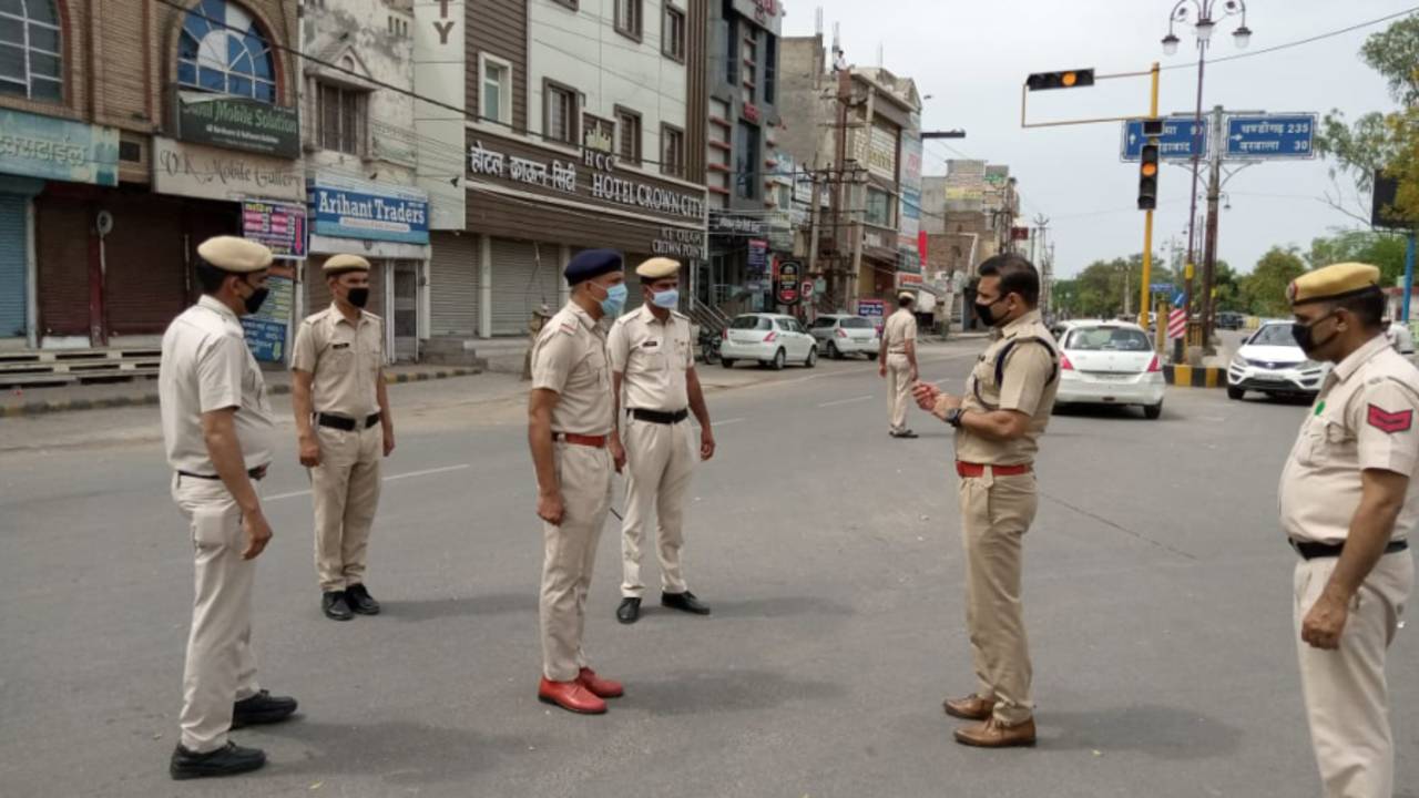 Joginder Sharma, former India player, now a police officer, talks to colleagues, Hisar, Haryana, April 2020
