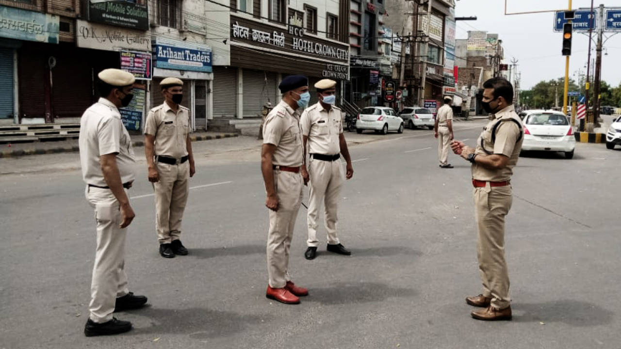 On the beat: Joginder Sharma (extreme right), out on duty in Hisar, talks to colleagues