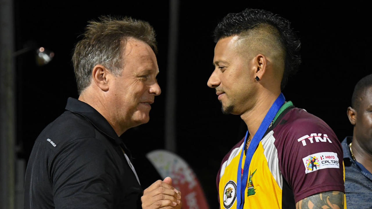 Chief Operations Officer (COO) Pete Russell hands Rayad Emrit a runners-up medal after the 2016 Caribbean Premier League final
