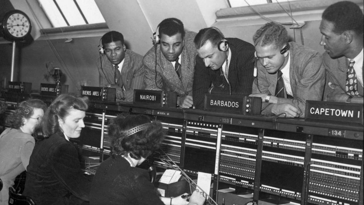 West Indies cricketers watch a telephone operator putting calls through to the West Indies for them from England, London, August 18, 1950