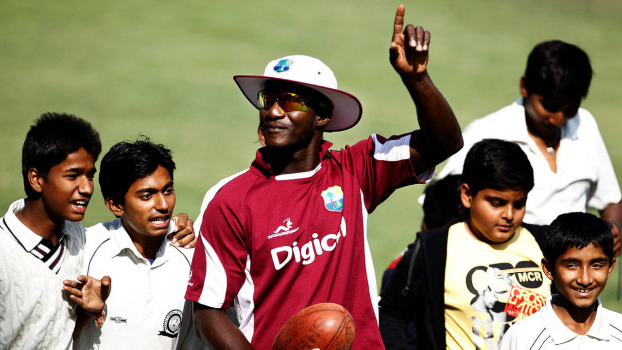 West Indies captain Darren Sammy is surrounded by ball boys wanting his autograph at the Holkar Stadium, Indore, December 7, 2011