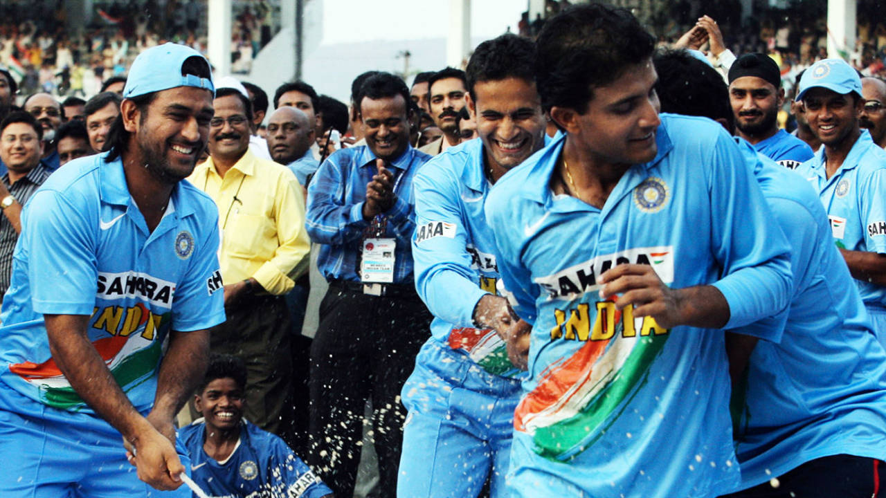 MS Dhoni sprays champagne on a fleeing Sourav Ganguly&nbsp;&nbsp;&bull;&nbsp;&nbsp;Raveendran/AFP/Getty Images