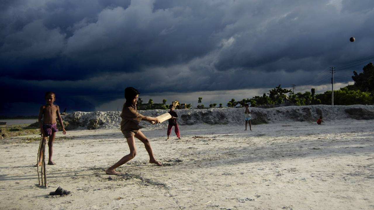 Cricket, despite the gathering storm clouds - in Kumarkhali, Bangladesh