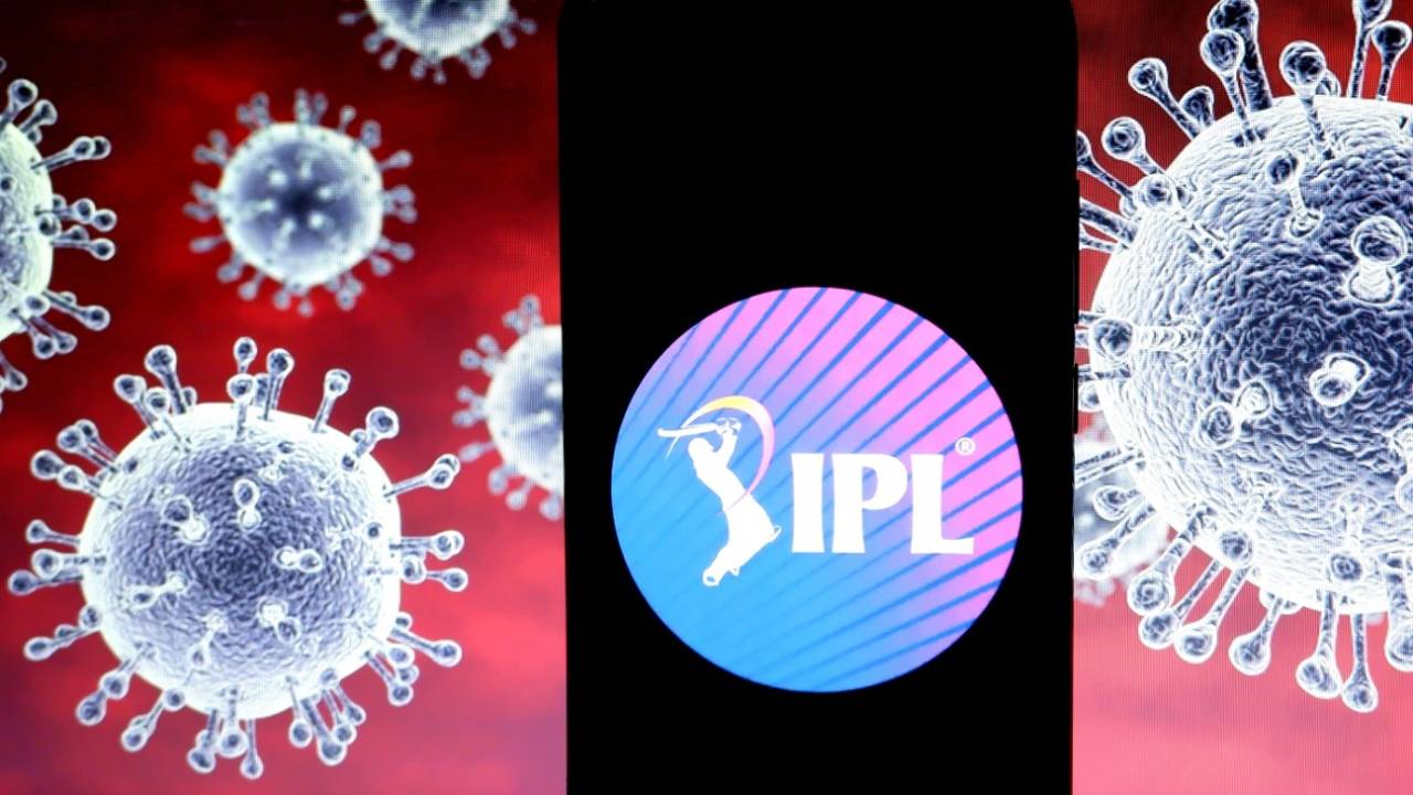 An IPL logo displayed on a smartphone with a computer model of the COVID-19 virus&nbsp;&nbsp;&bull;&nbsp;&nbsp;Getty Images