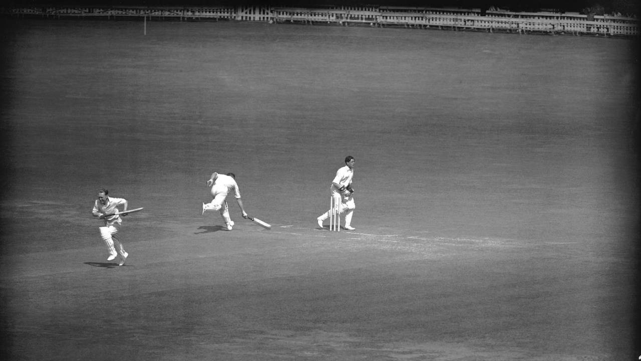 Warwickshire's Charlie Grove is run out by Middlesex's Michael Laws as Eric Hollies sprints to the other end