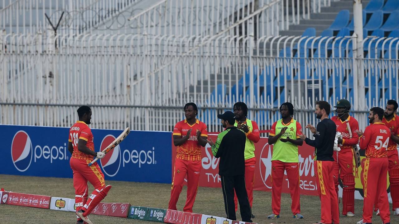 The Zimbabwe players give Elton Chigumbura a guard of honour in his last international game
