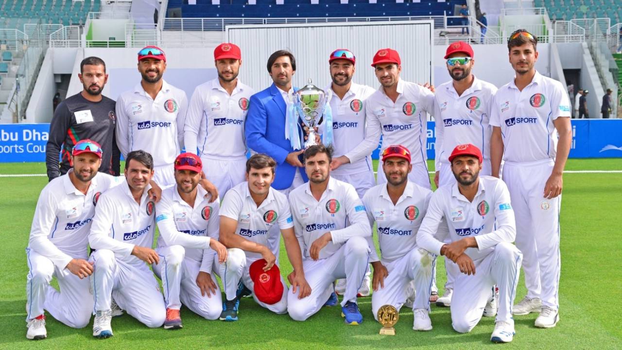 The Afghanistan players pose with the series trophy after winning the second Test, Abu Dhabi, March 14, 2021