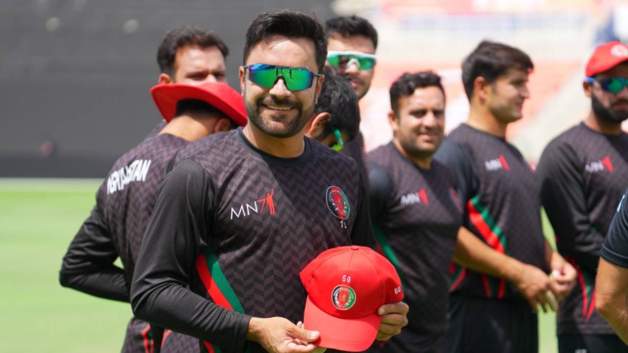Rashid Khan poses with a special cap gifted to him on the occasion of his 50th T20I appearance, Abu Dhabi, March 19, 2021