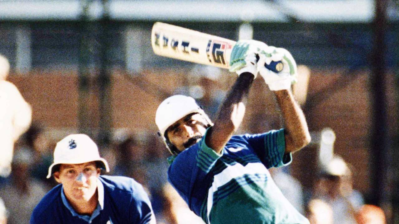 Wicketkeeper Jack Richards watches Javed Miandad make his way to 59 off 65 balls