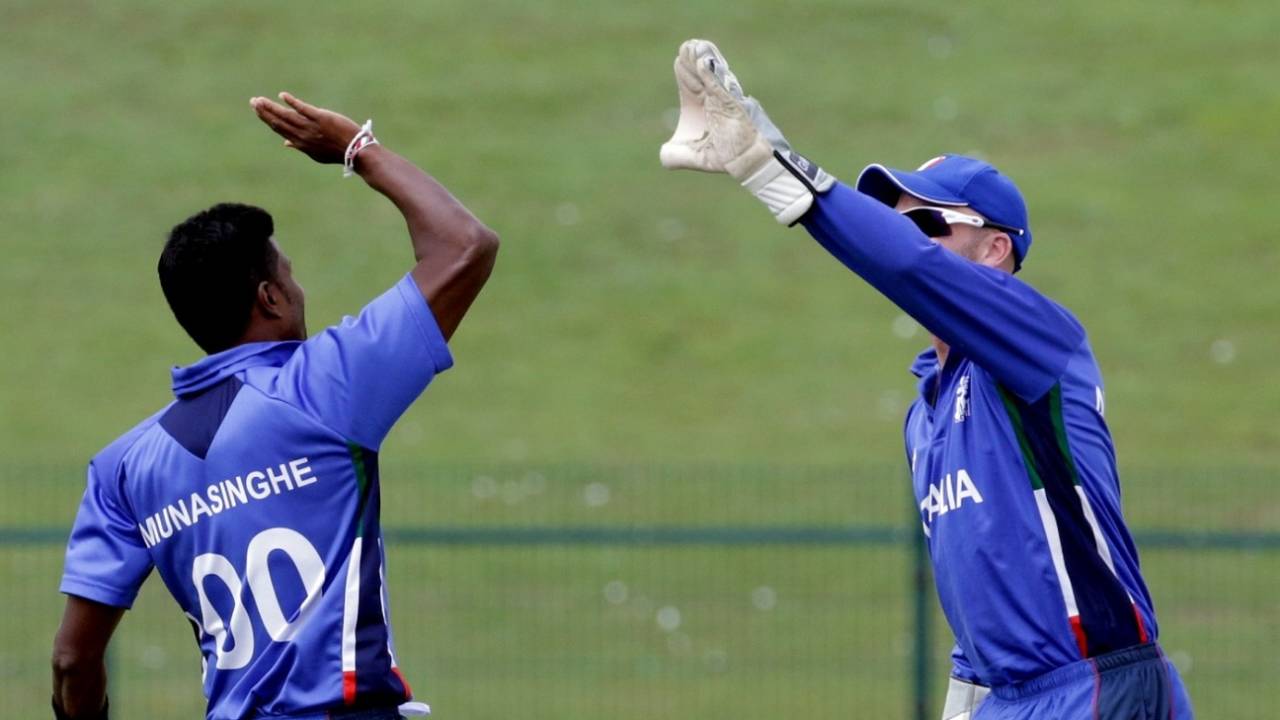 Gayashan Munasinghe of Italy celebrates a wicket with wicketkeeper Andy Northcote, Abu Dhabi, November 24, 2013
