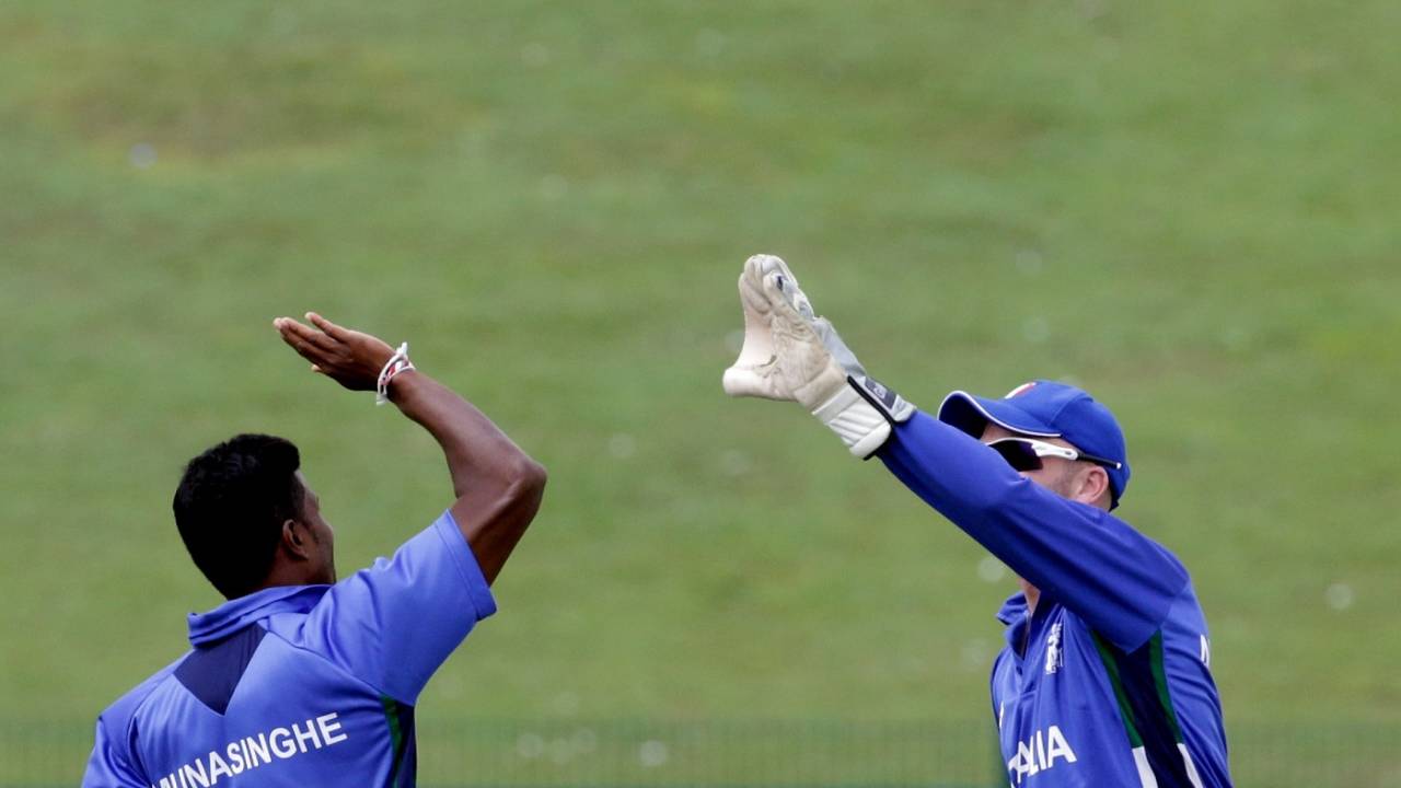 Gayashan Munasinghe of Italy celebrates a wicket with wicketkeeper Andy Northcote