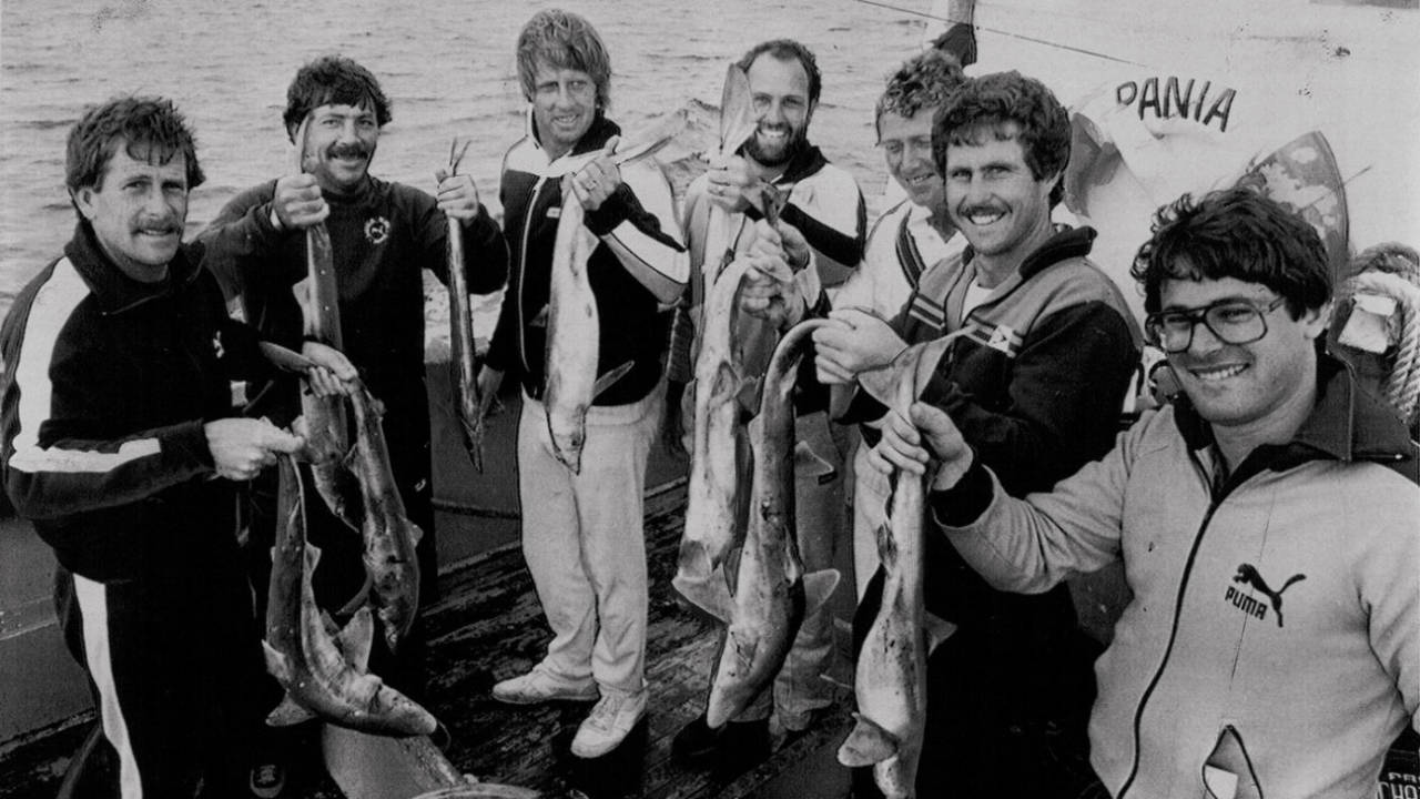 Bruce Laird, Rod Marsh, Jeff Thomson, Ray Bright, Kim Hughes, Grame Wood and the team masseur show off the catch they got at Cape Saunders, February 1982