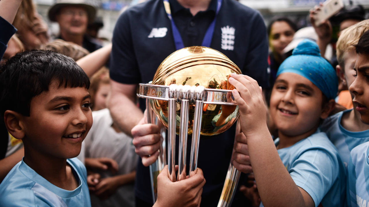 Eoin Morgan gives young fans an opportunity to get up close with the World Cup trophy, The Oval, July 15, 2019