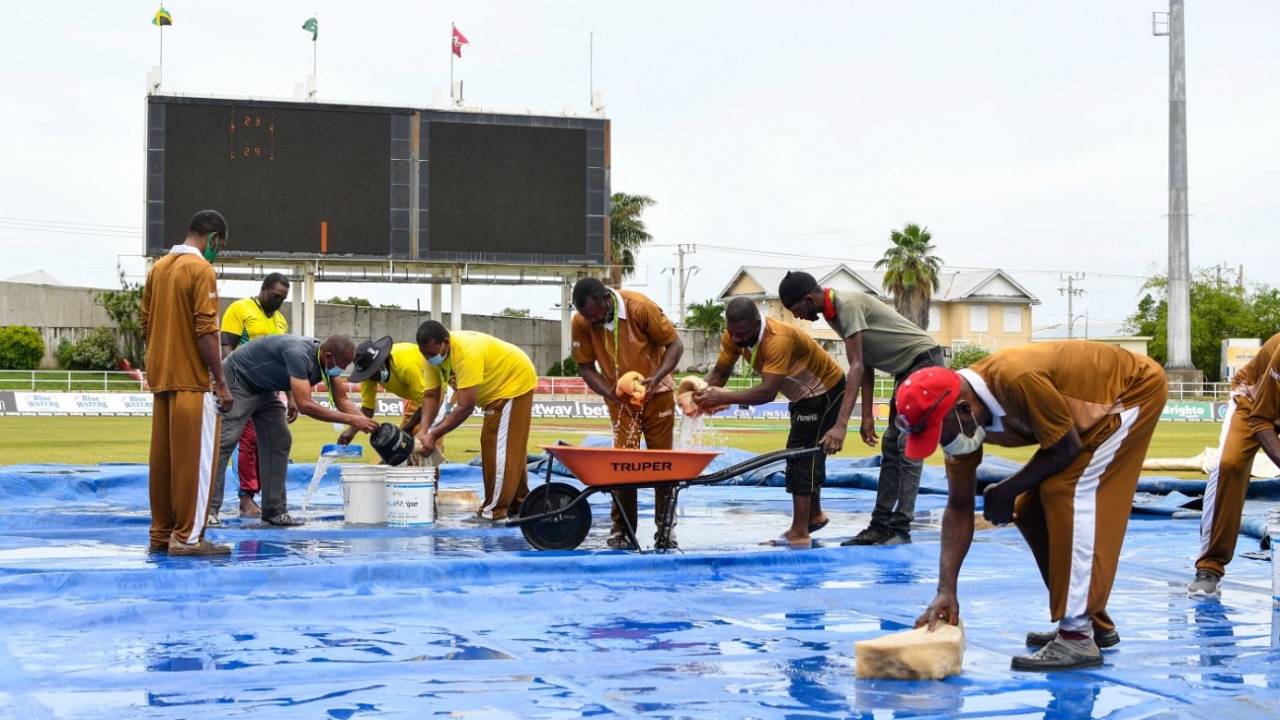 The ground staff at Sabina Park mop up water from the covers, West Indies vs Pakistan, 2nd Test, Jamaica, 2nd day, August 21, 2021