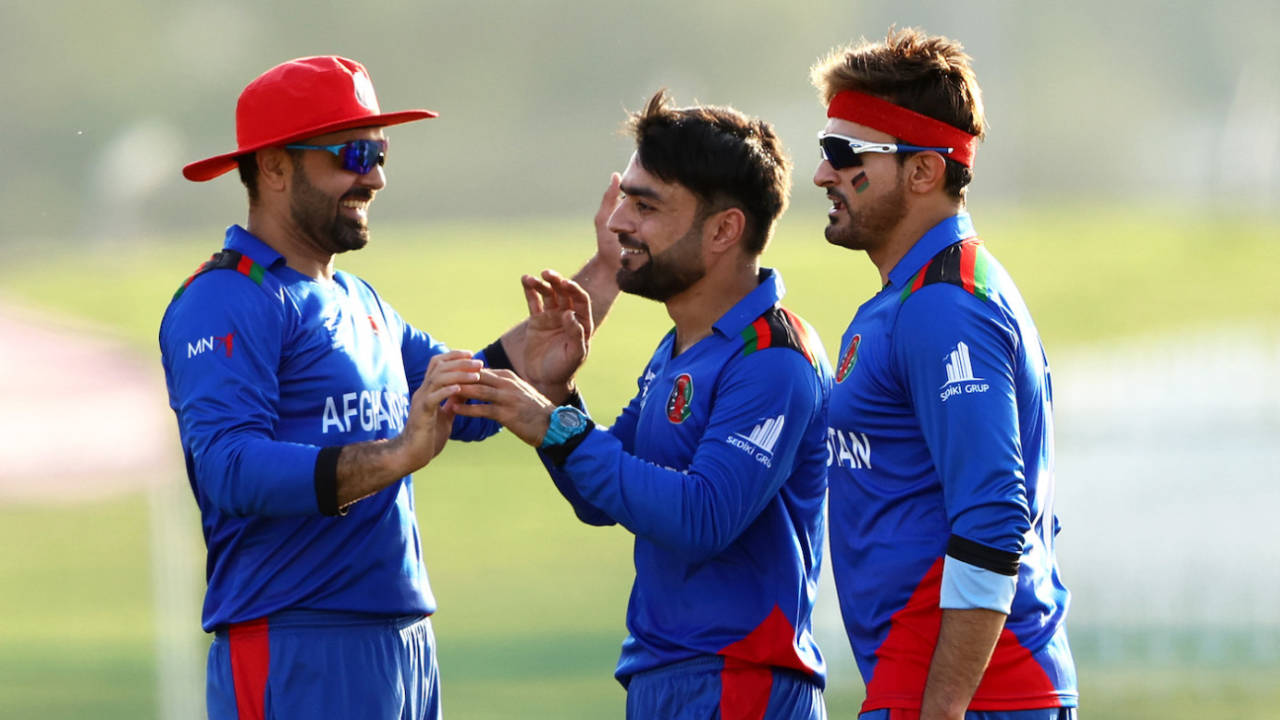 Mohammad Nabi, Hamid Hassan and Rashid Khan celebrate during a match&nbsp;&nbsp;&bull;&nbsp;&nbsp;Getty Images