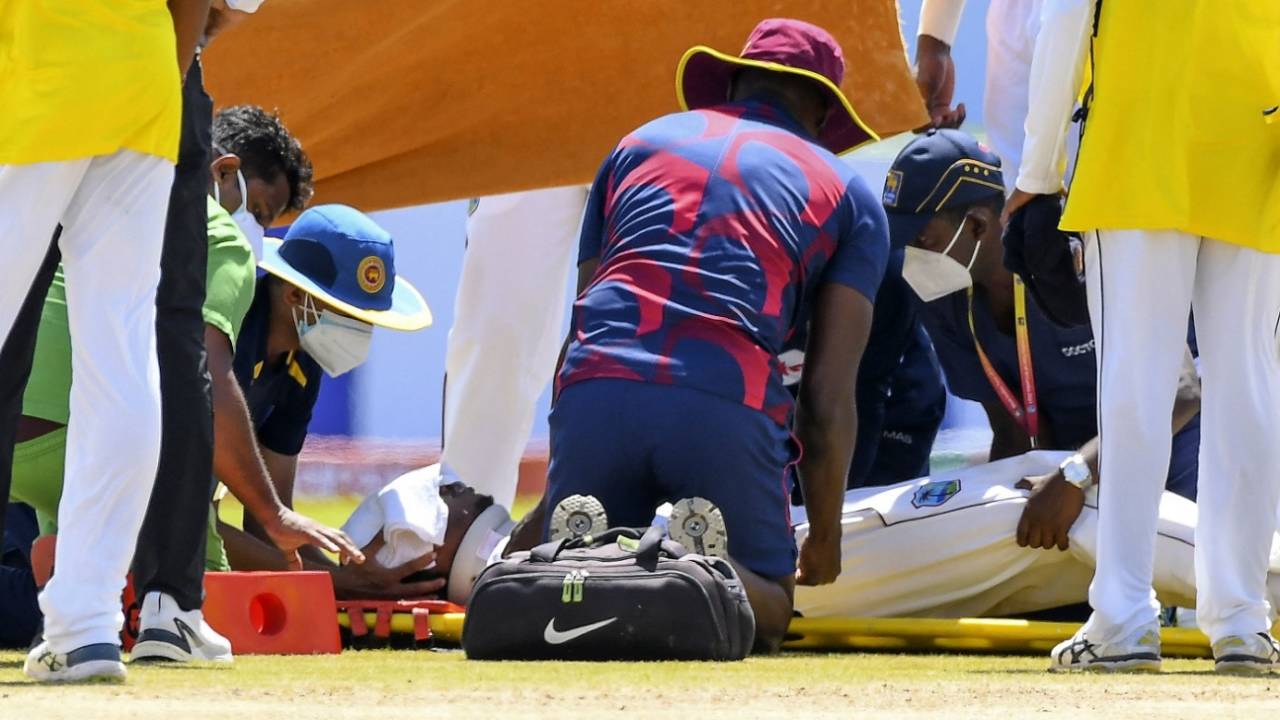 Medical teams from both Sri Lanka and West Indies attend to Jeremy Solozano, with a towel covering his forehead, Sri Lanka vs West Indies, 1st Test, Galle, 1st day, November 21, 2021