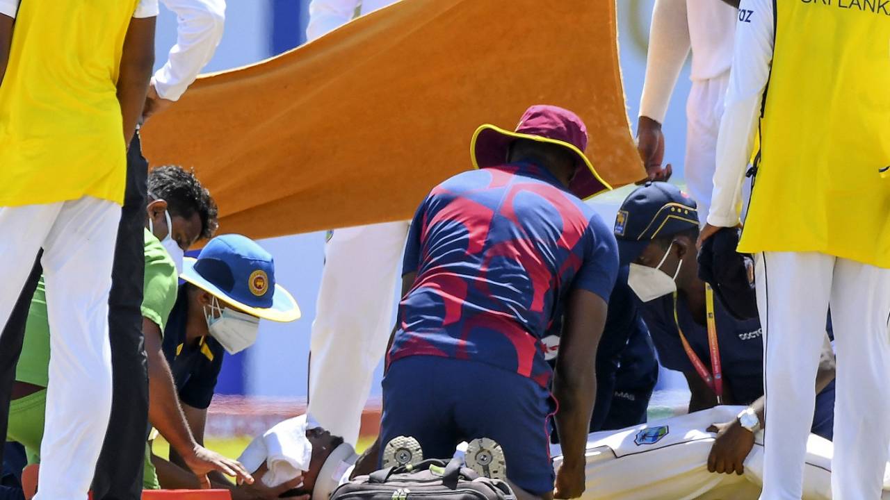 Medical teams from both Sri Lanka and West Indies attend to Jeremy Solozano, with a towel covering his forehead, Sri Lanka vs West Indies, 1st Test, Galle, 1st day, November 21, 2021