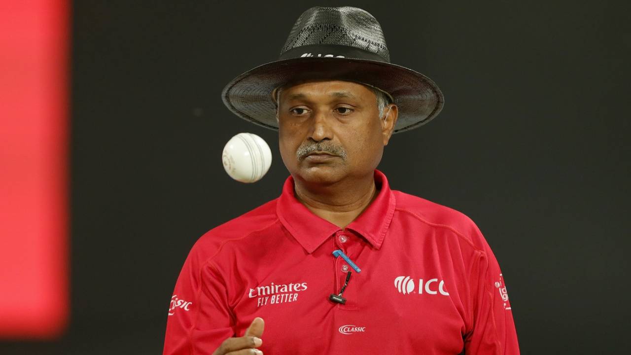Umpire KN Ananthapadmanabhan tosses the ball up