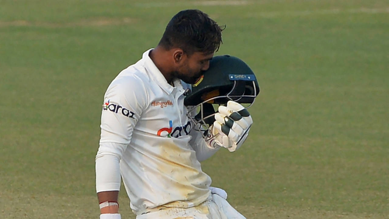 Liton Das kisses the logo on his helmet after getting to his maiden Test century&nbsp;&nbsp;&bull;&nbsp;&nbsp;AFP/Getty Images