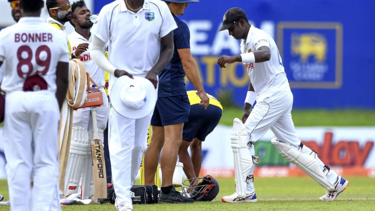 Angelo Mathews stretches the sore area after picking up a thigh strain, Sri Lanka vs West Indies, 2nd Test, Galle, 2nd day, November 30, 2021
