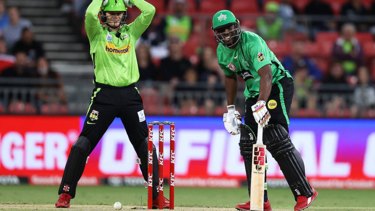 Andre Russell and Sam Billings share contrasting smiles after the ball hit the stumps but the bails didn't come off, Sydney Thunder vs Melbourne Stars, BBL 202-21, Sydney Showground Stadium, December 12, 2021
