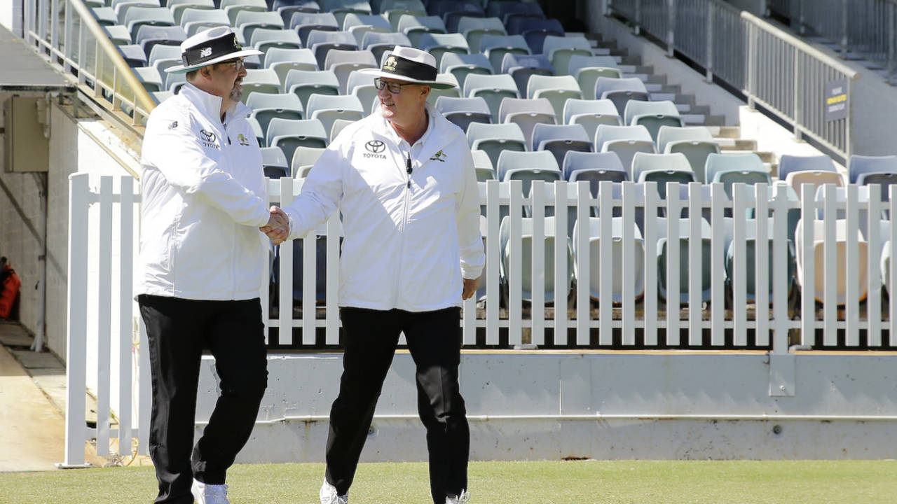 Umpires Michael Graham-Smith and Darren Close walk out onto the field, Western Australia vs Tasmania, Sheffield Shield, Perth, October 27, 2021