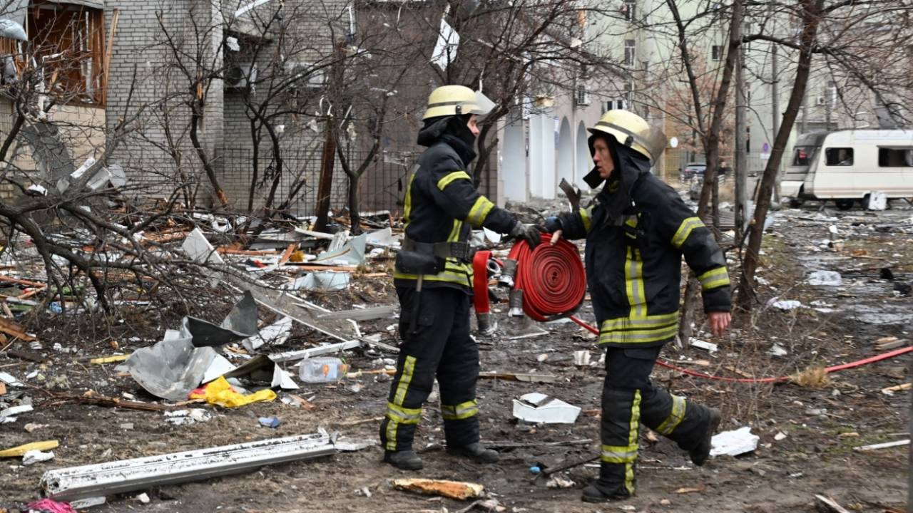 Firefighters work at a damaged residential building in a suburb of Kyiv, following Russia's invasion of Ukraine, February 25, 2022