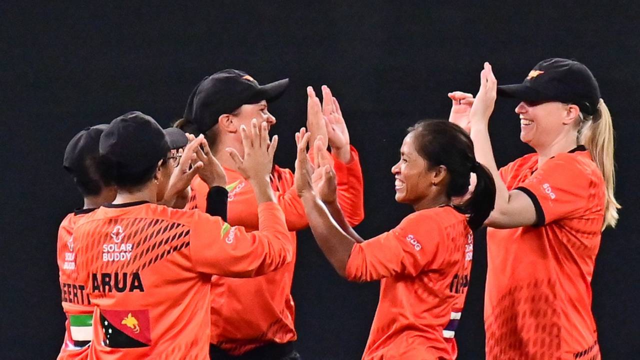 Falcons players celebrate the fall of a wicket against Warriors