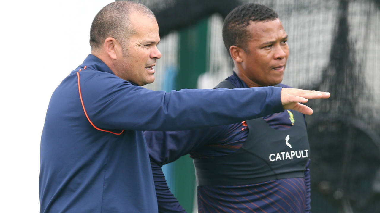Charl Langeveldt talks with Glenton Stuurman, Old Trafford, August 23, 2022