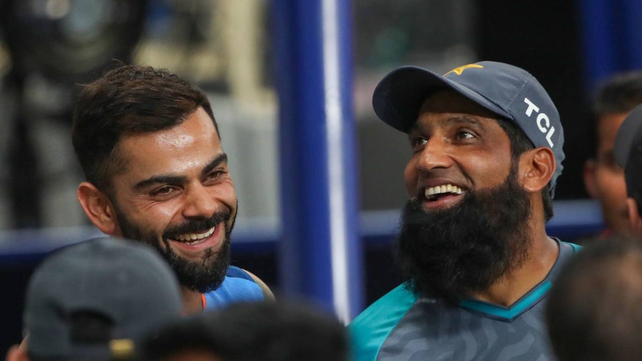 Virat Kohli and Mohammad Yousuf share a light moment after the match