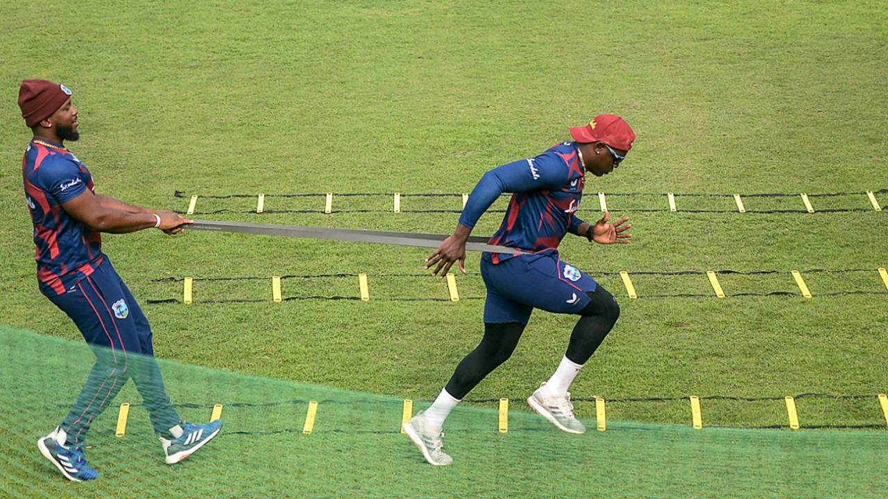 Sunil Ambris helps Rovman Powell train using resistance bands, Dhaka, January 17, 2021