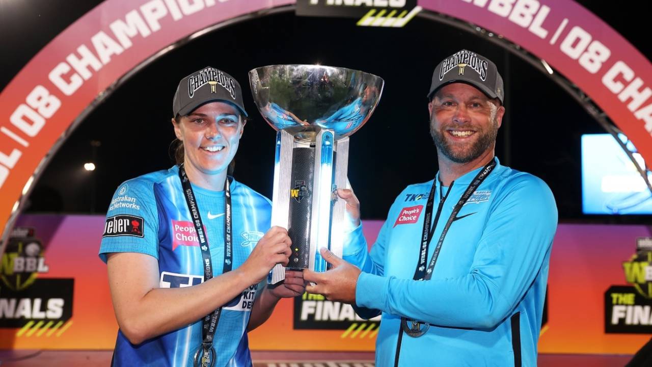Tahlia McGrath poses with the winner's trophy alongside coach Luke Williams&nbsp;&nbsp;&bull;&nbsp;&nbsp;Cricket Australia via Getty Images