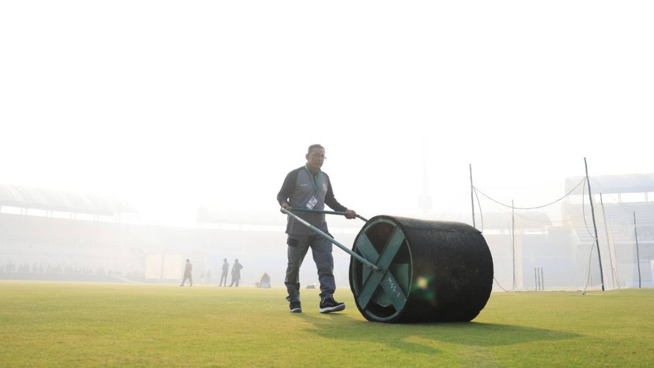 The fog hangs over Multan as the groundsman rolls the nets, December 8, 2022