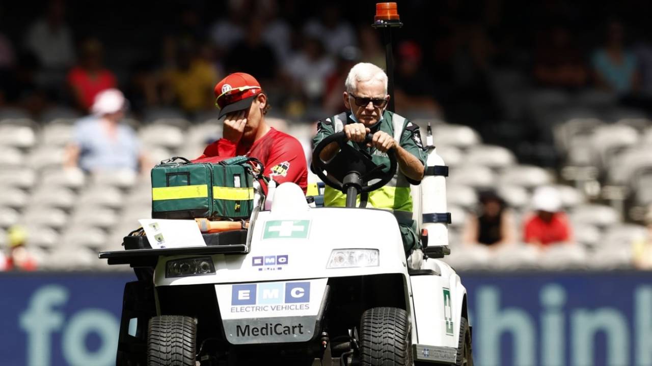 Nic Maddinson is stretched off after injuring his left knee, Melbourne Renegades vs Perth Scorchers, Big Bash League 2022-23, Melbourne, January 01, 2022