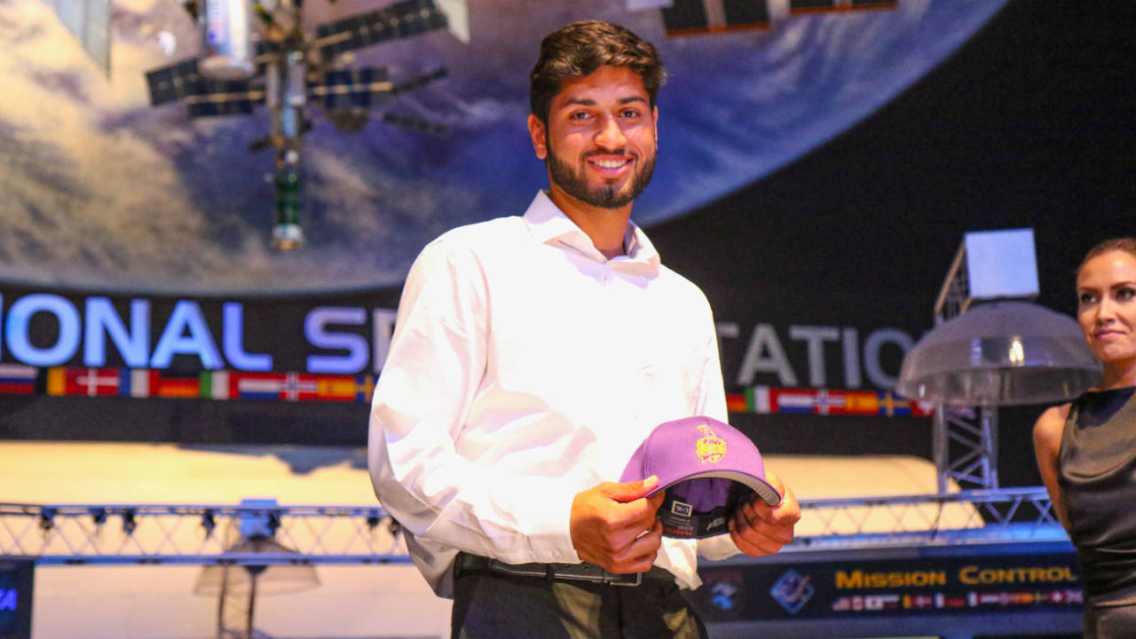 Ali Sheikh accepts his LA Knight Riders cap after being taken in the sixth round of the MLC Draft, Houston, March 19, 2023