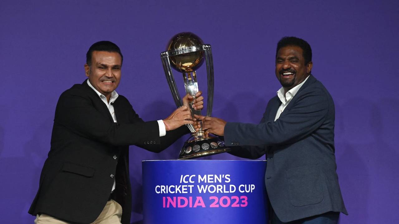 Virender Sehwag and Muthiah Muralidaran, both former ODI World Cup winners, mock tussle with the trophy at an event, Mumbai, June 27, 2023