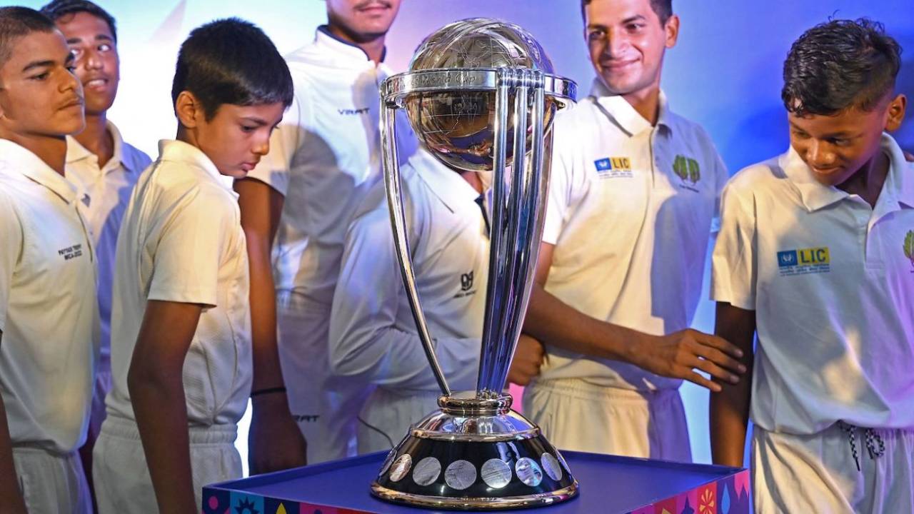 Young boys with the World Cup trophy in Mumbai, July 4, 2023
