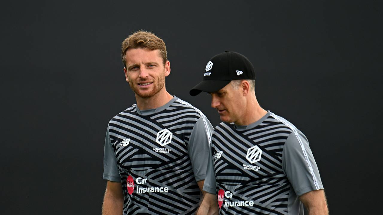 Jos Buttler and Simon Katich wait for the rain to clear