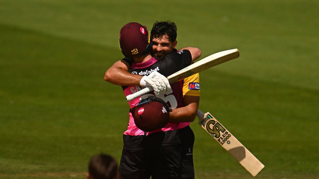 Andrew Umeed celebrates his century with team-mate Curtis Campher