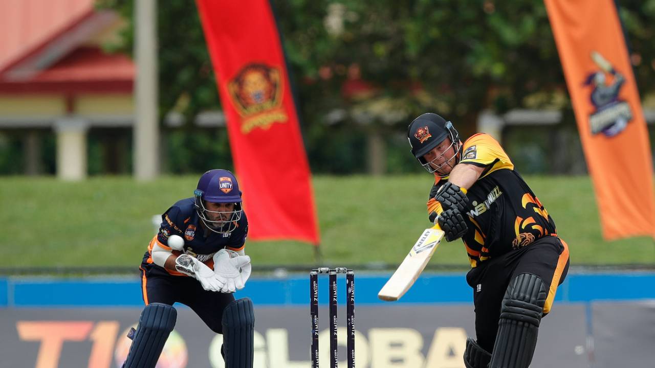 Richard Levi, who made 66, smacks the ball as Parthiv Patel watches
