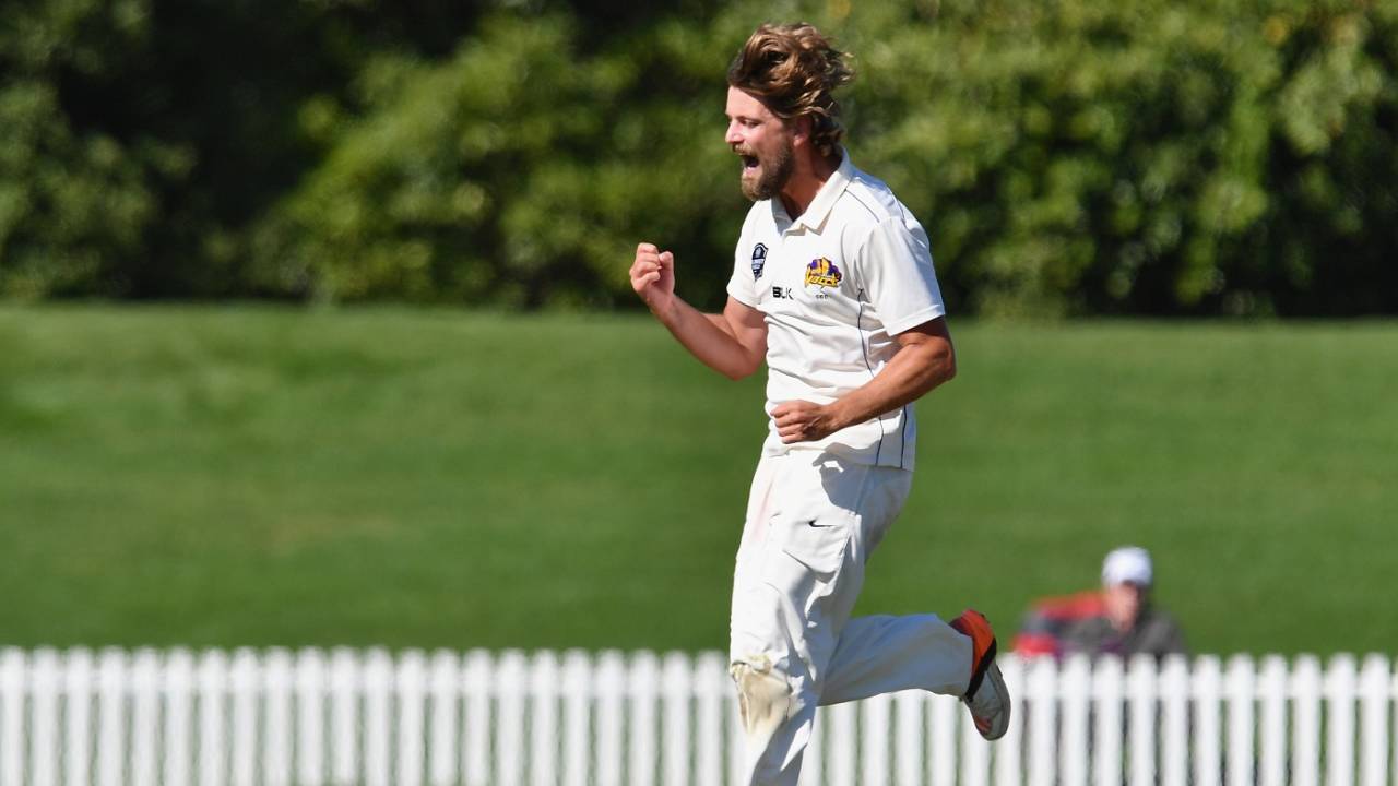 Sam Wells celebrates the wicket of Chad Bowes
