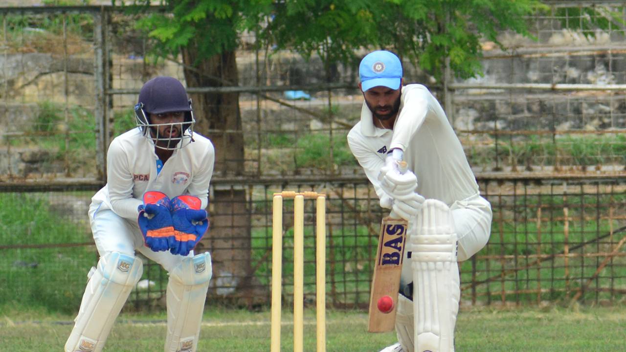 Gitansh Khera defends one as Salil Arora looks on from behind the stumps