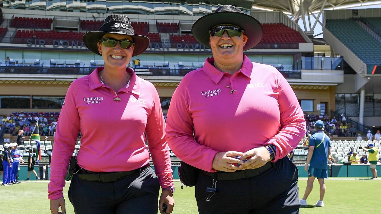 Umpires Claire Polosak and Sue Redfern are all smiles as they walk out to officiate