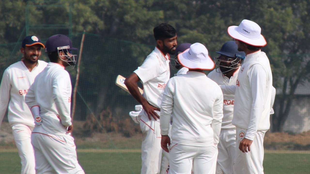 Mahesh Pithiya gets together with his team-mates after a wicket