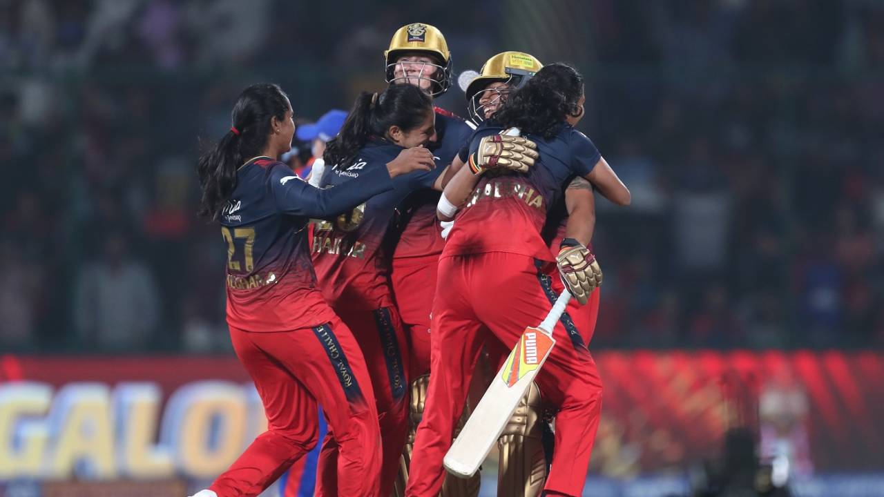 Ellyse Perry and Richa Ghosh are embraced by their RCB team-mates
