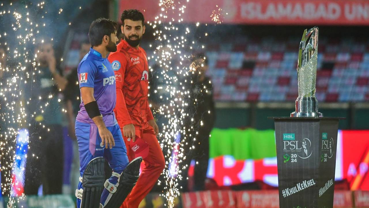 Mohammad Rizwan and Shadab Khan walk out as the fireworks go off