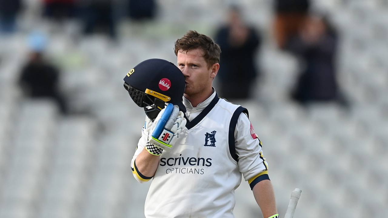 Alex Davies kisses the badge after notching a double-hundred on day one
