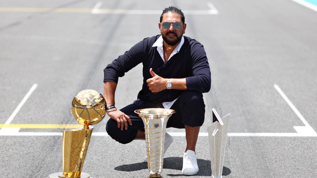 Yuvraj Singh with the Formula One World Championship trophy, Larry O'Brien Championship Trophy, and the ICC men's T20 World Cup trophy on the grid before the Miami F1 Grand Prix, Miami International Autodrome, May 5, 2024