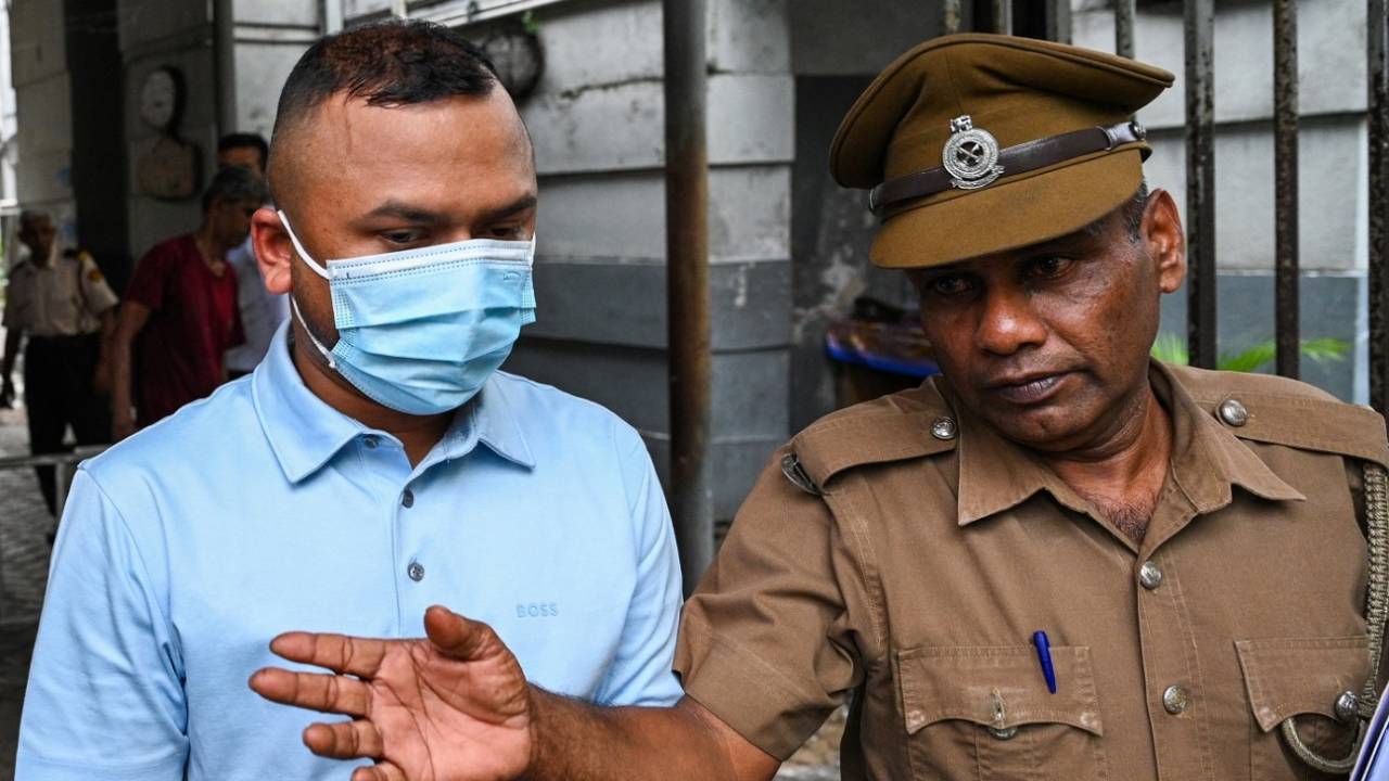 Tamim Rahman, a owner of the Dambulla franchise in the LPL in Sri Lanka, is escorted by a policeman, Colombo, May 22, 2024