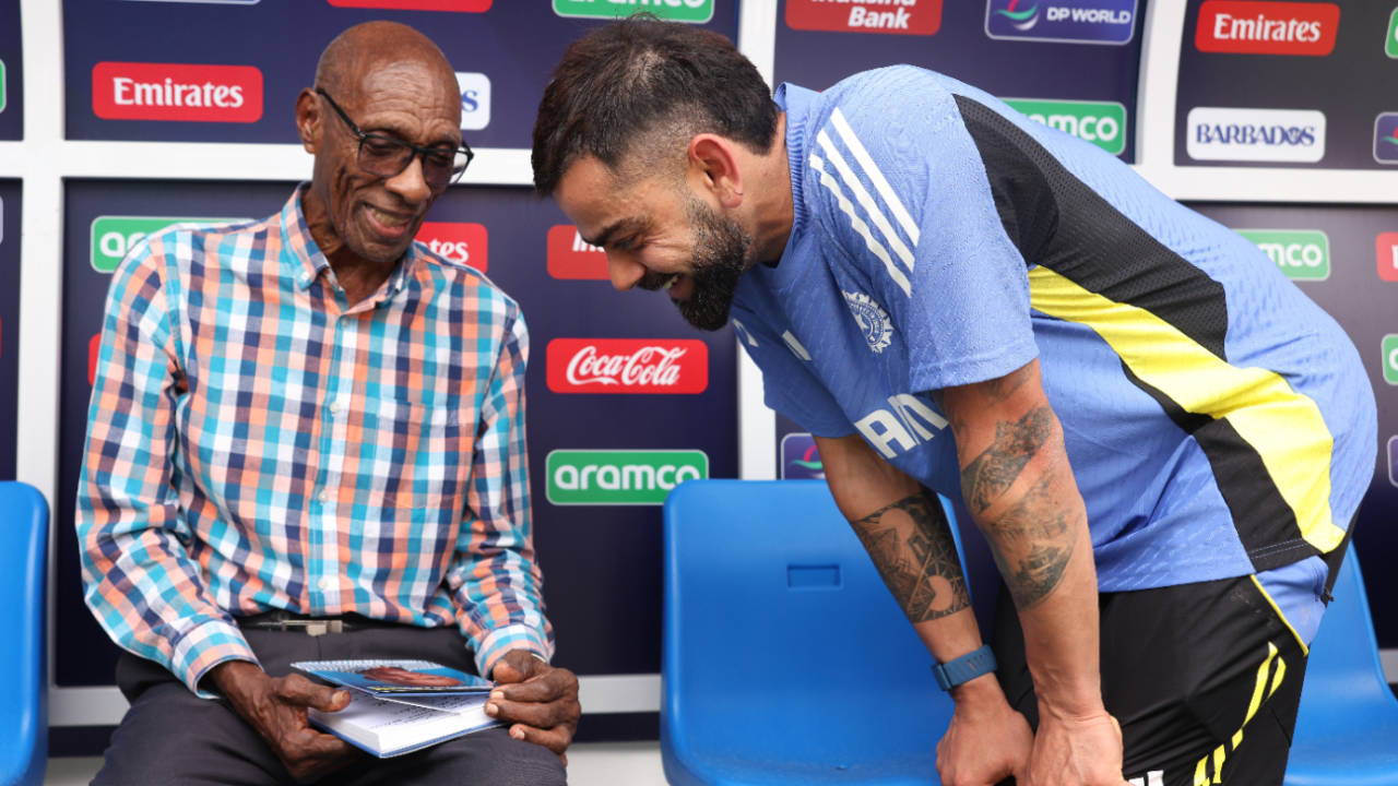 Wes Hall has a chat with Virat Kohli while presenting him with his book, Bridgetown, Barbados, June 18, 2024